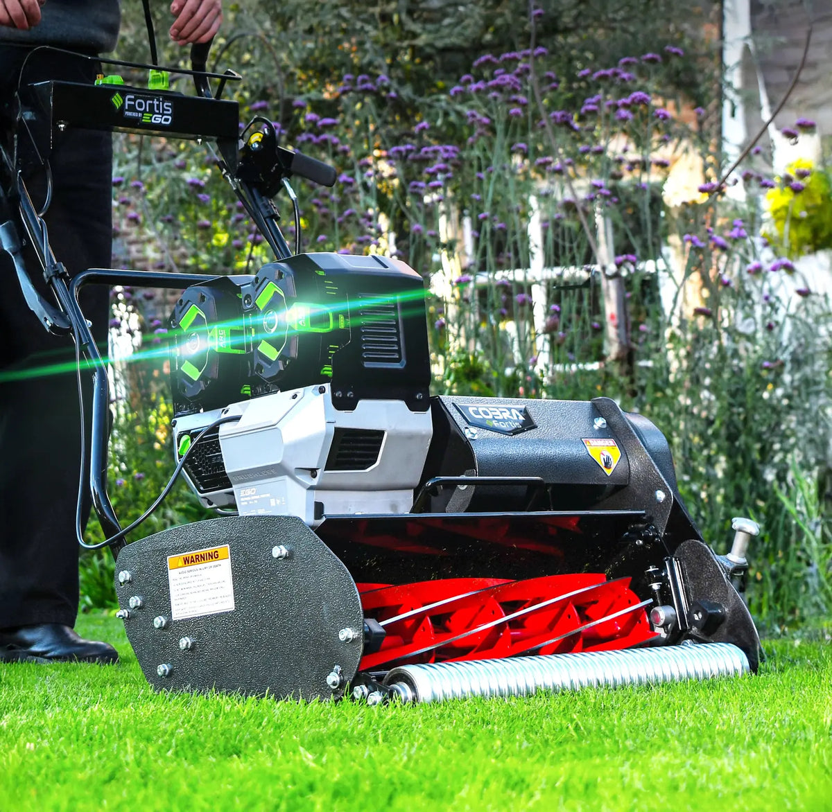 Cobra Fortis 20FTE 20 inch cylinder mower shown from the side on a striped lawn