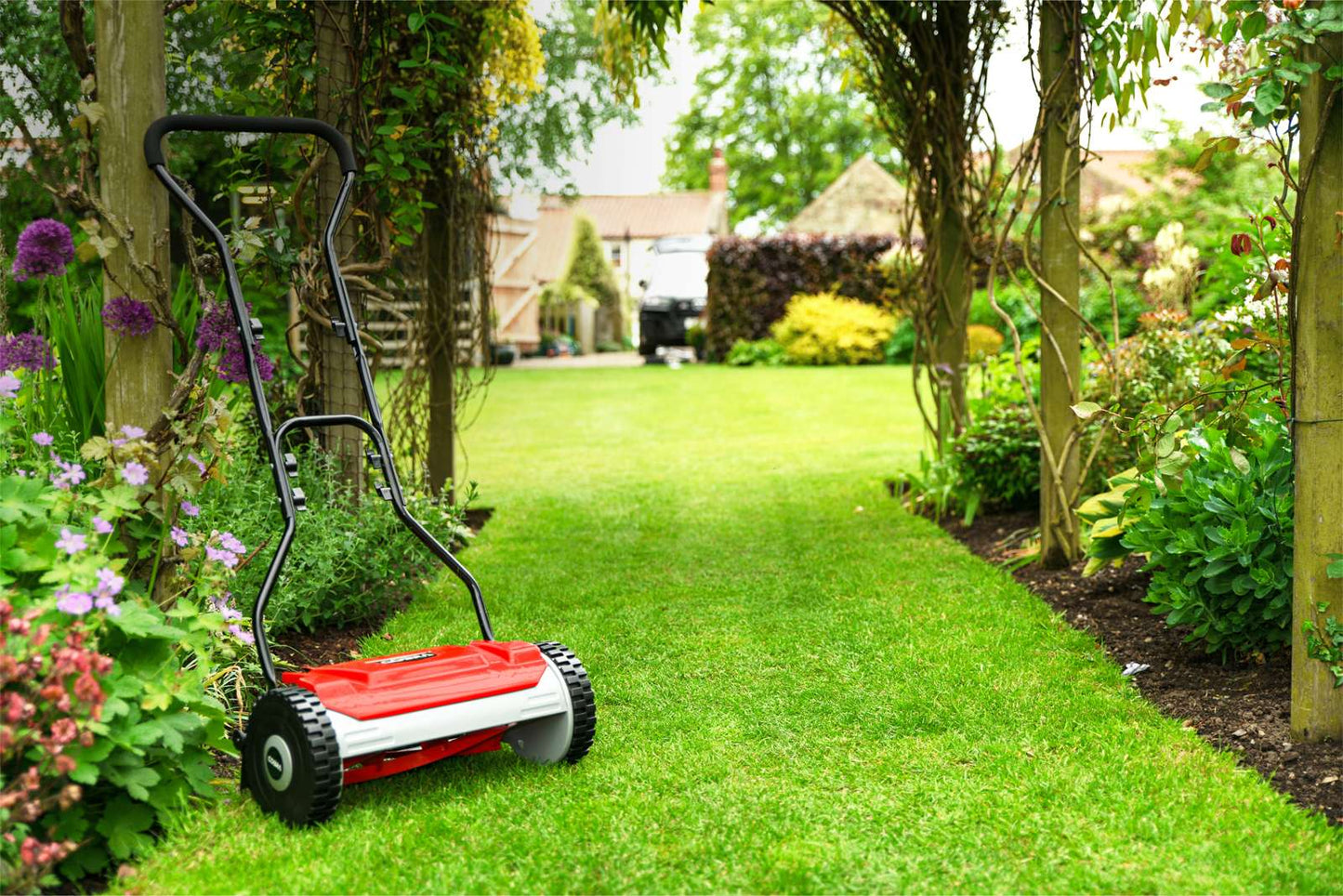 Cobra HM381 cylinder lawnmower being used on a garden lawn